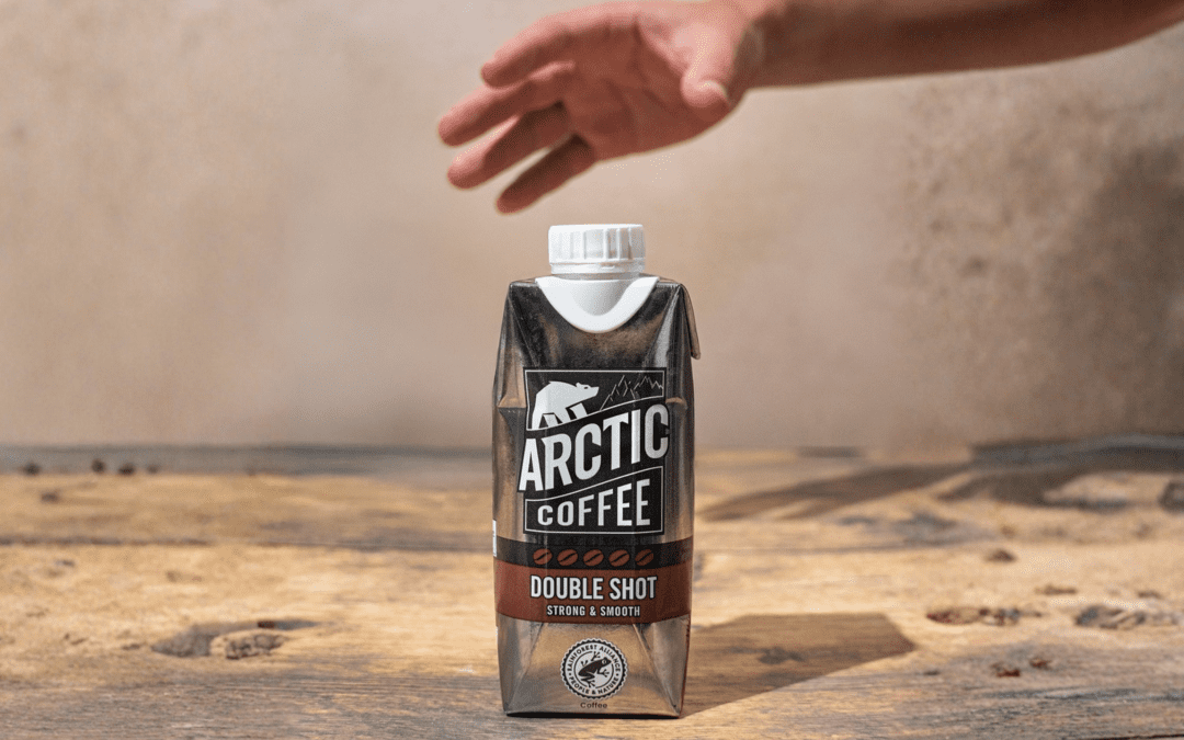 person grabbing an Arctic Iced Coffee Double Shot carton
