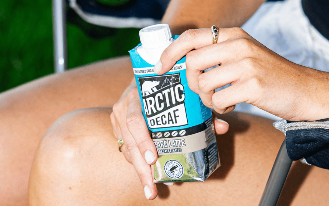 Person holding Decaf bottle